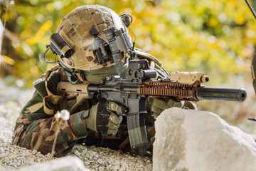 marines with a rifle aiming at a target