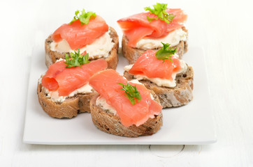 Sandwiches with salmon on white plate