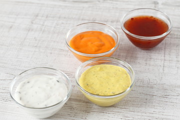 Garlic, chili, curry and cocktail sauce in small bowls