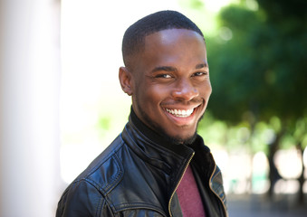 Cheerful young african american man smiling outside