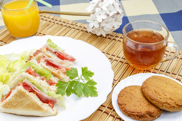 Huge breakfast with sandwich, orange juice, sweet and tea