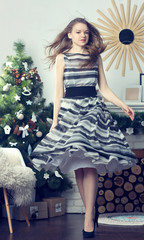 Very cute girl on the background of the Christmas tree