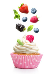 Cupcake  with butter cream and falling strawberry