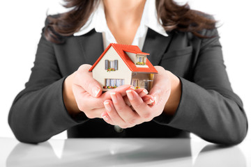 insurance and protection concept - realtor woman gives a house