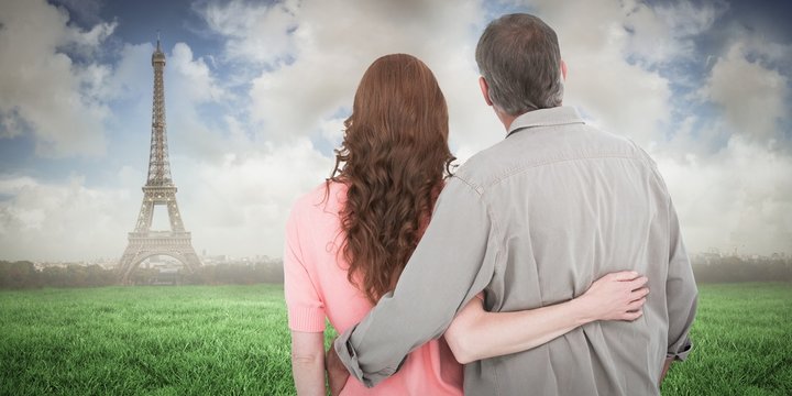 Composite image of casual couple standing arm around