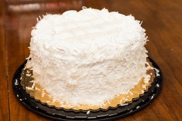 Whole Coconut Cake on Wood Table