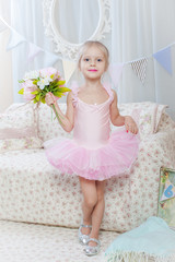 Little girl stand with flowers