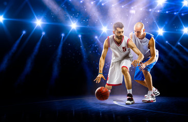 Obraz premium Two basketball players in spotlights
