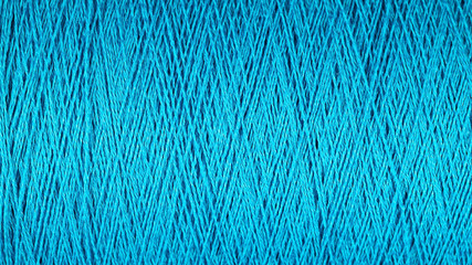 Spool of blue thread macro background