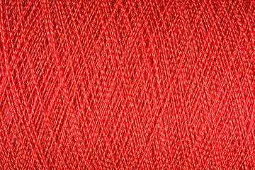 Spool of orange thread macro background