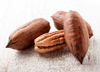 pecan nuts on white wood