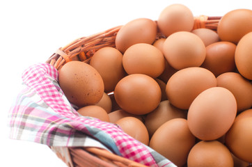 Chicken brown eggs in wicker basket