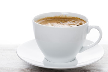 close-up of cup of coffee on a white table