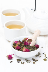 green tea with rosebuds in a bowl, cups and teapot