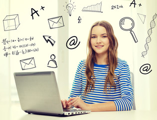 smiling teenage gitl with laptop computer at home