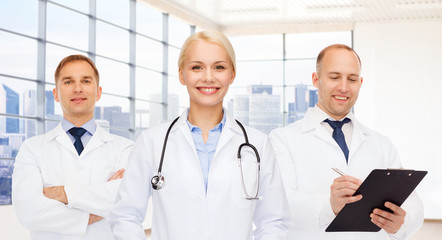 group of smiling doctors with clipboard