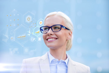 young smiling businesswoman in eyeglasses outdoors
