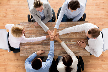 close up of business team with hands on top