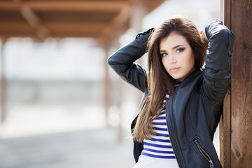 Beautiful fashionable young woman outdoors in the summer.