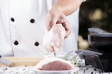 Chef holding raw pork