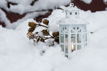 Burning lantern winter day