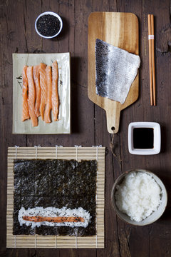 overhead shot of ingredients for preparing sushi on table