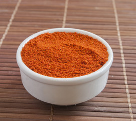 Paprika ground in a white bowl close up