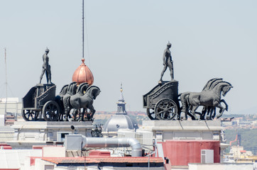 Obraz premium Statues on roof of Banco Bilbao Vizcaya Madrid Spain