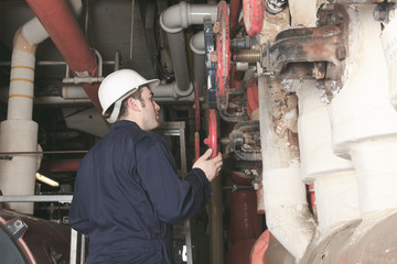 maintenance engineer checking technical data of heating system e