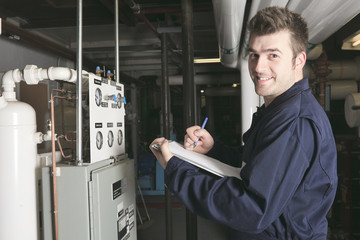 maintenance engineer checking technical data of heating system e