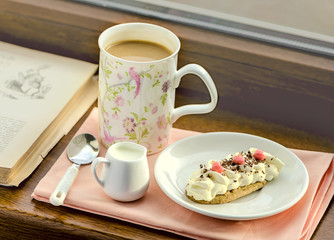 Coffee with milk and cake and candy hearts