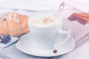 Coffee cup and croissant