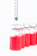 Closed up Disposable syringe put on injection vials