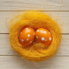 Fototapeta na wymiar Orange Easter eggs in the nest