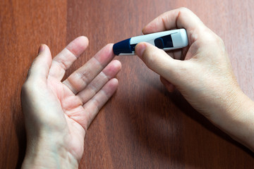 the hand of the elderly woman lies near the device for measureme