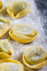 Preparation of ravioli pasta on black slate background