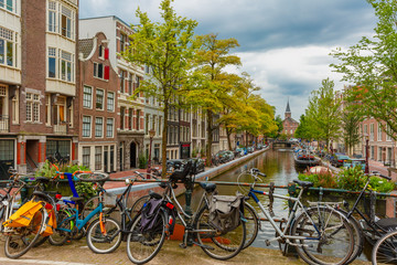 Fototapeta na wymiar Amsterdam canal and bridge with bikes, Holland, Netherlands