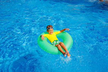 Boy swims in a pool