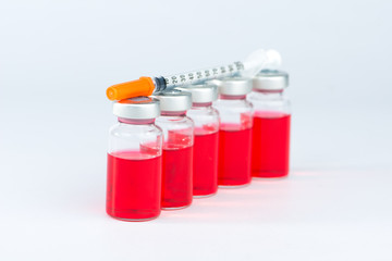 Disposable syringe on injection vials