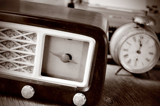 antique radio, alarm clock and typewriter, in sepia toning