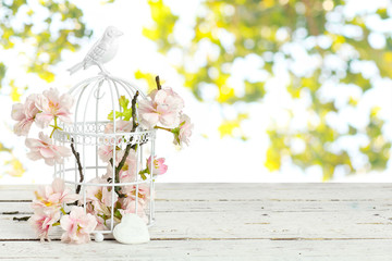 spring flowers in  birdcage - Powered by Adobe
