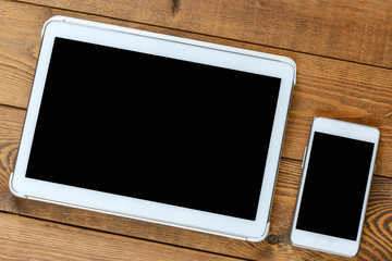 Tablet and smartphone on an old wood