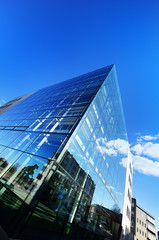 Modern building glass facade against sky