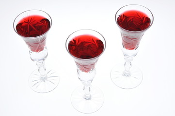 Alcoholic liquors in the crystal glasses isolated on white