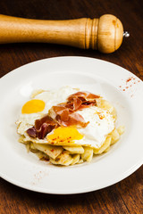 Eggs, potatoes and serrano ham. Huevos rotos.