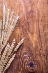 copyspace background eras of wheat on old wooden boards
