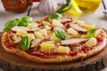 Pizza with cheese and pineapple chicken on board