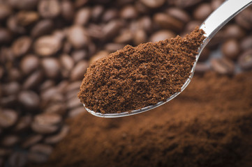 Iron spoon with coffee powder close up