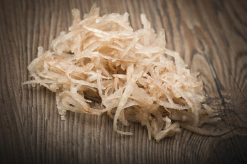 Topinambur, Jerusalem artichoke cut into julienne on the table