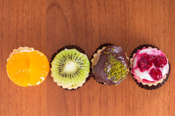 Colorful Cakes on Wooden Background